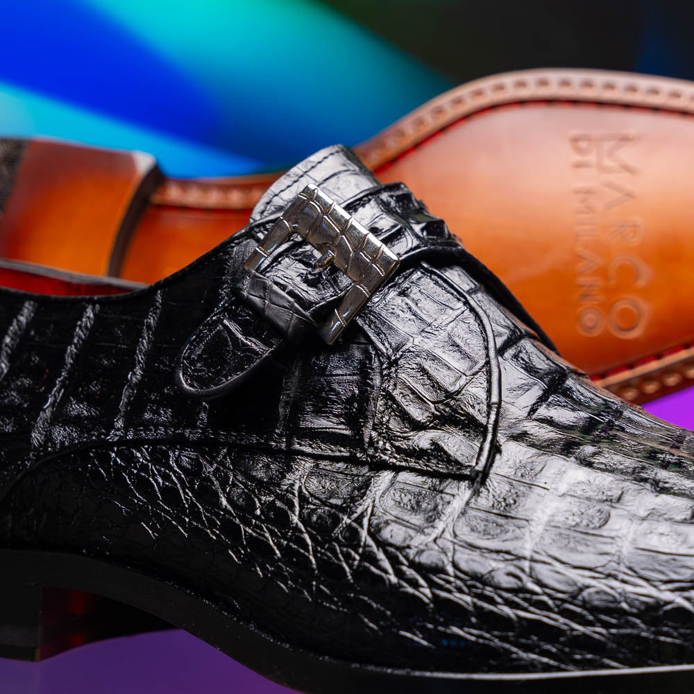 The Marco Di Milano Rovigo Black is a luxury monk strap dress shoe featuring genuine caiman crocodile, a pointed toe, metal buckle, and brown leather sole, displayed on a clean white background.