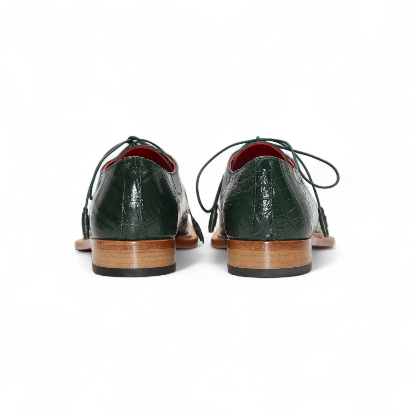 The Fennix Rowan Green by Fennix of Italy is a dark green, crocodile-patterned leather dress shoe with laces, brown sole, and low heel, crafted in Italy and shown from the side on a white background.