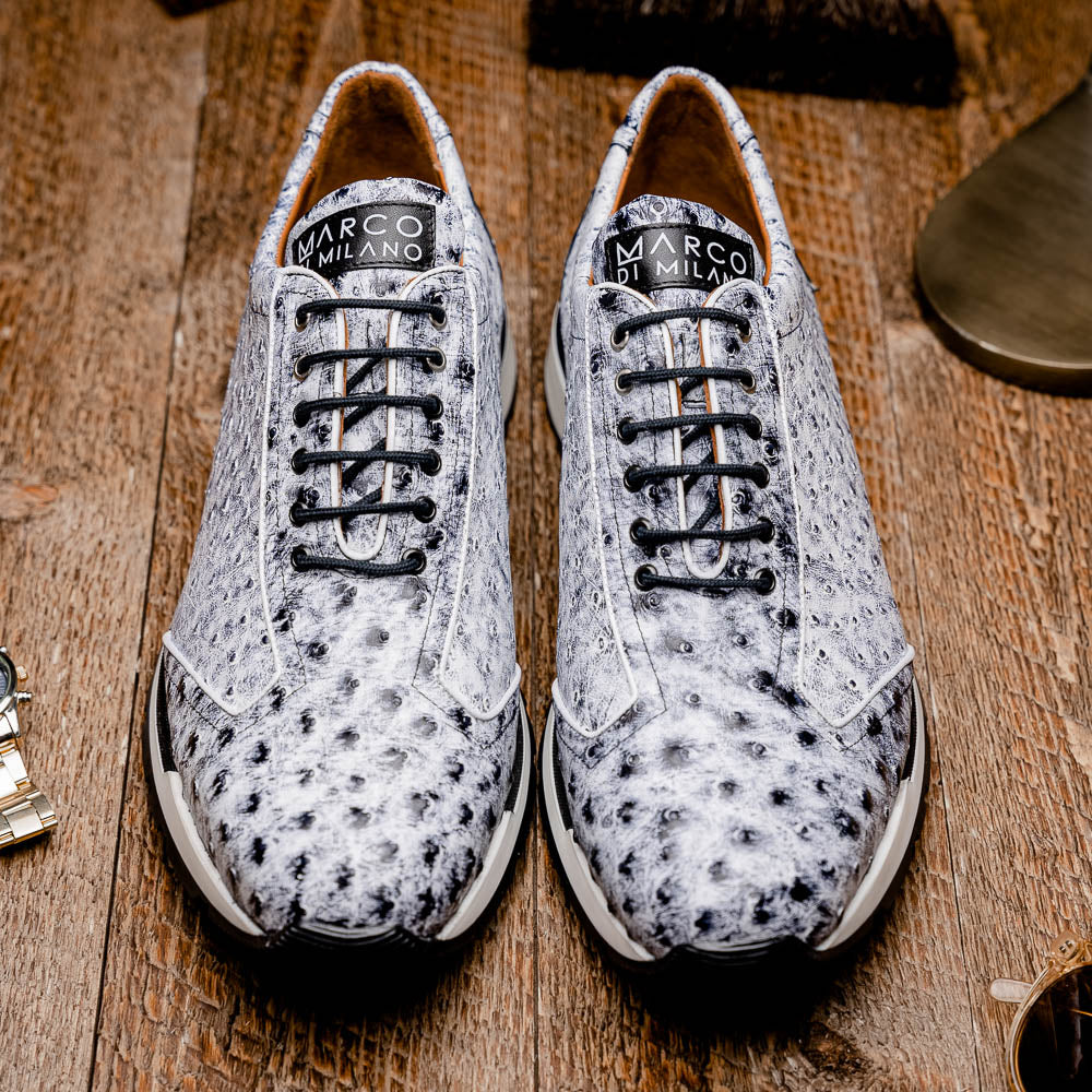 The Marco Di Milano Scanno Newspaper sneakers feature a luxurious hand-painted white and black textured lace-up design with thick black rubber soles, displayed against a plain white background.