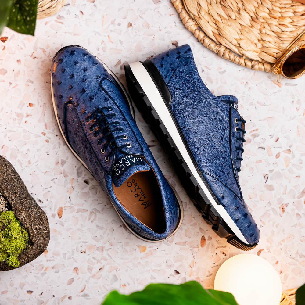 The Marco Di Milano Scanno Antique Navy sneaker features genuine ostrich quill leather in blue, black laces, a white and black rubber sole, and textured details—luxury footwear displayed on a white background.