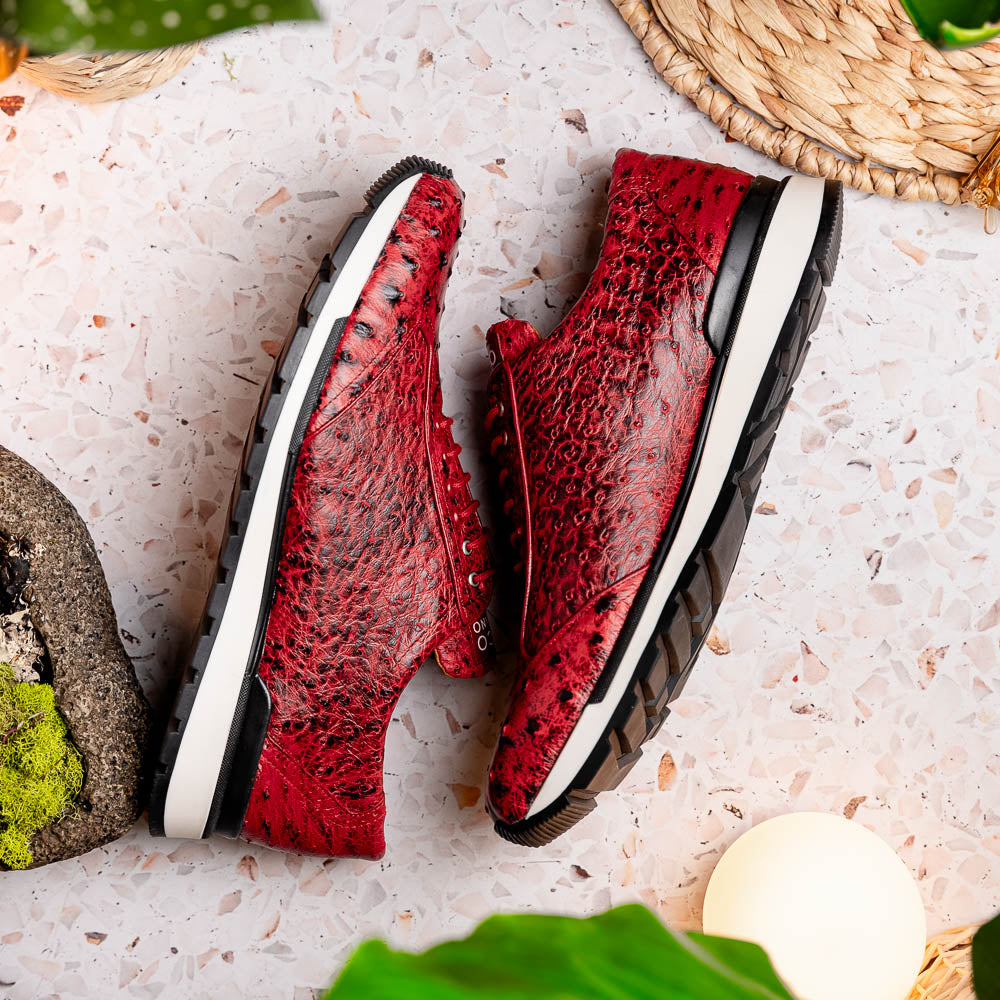 The Marco Di Milano Scanno Antique Red is a luxury fashion sneaker in textured genuine ostrich quill leather with black and white rubber soles, shown upright and on its side against a plain white background.