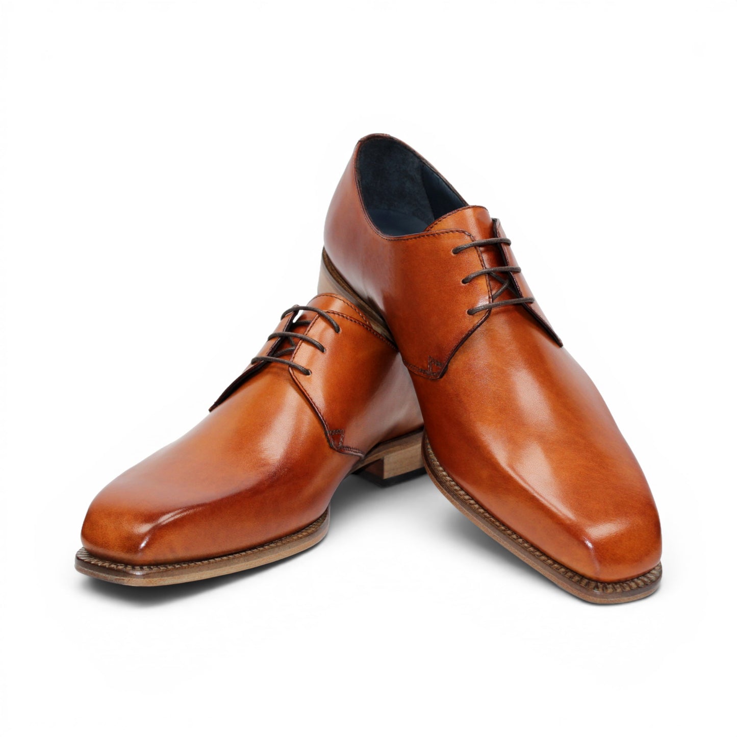 The Duca Sermoneta Cognac by Duca Di Matiste, a classic brown Italian leather dress shoe with a low wooden heel and black lining, is shown in a side view against a white background, highlighting its timeless elegance.