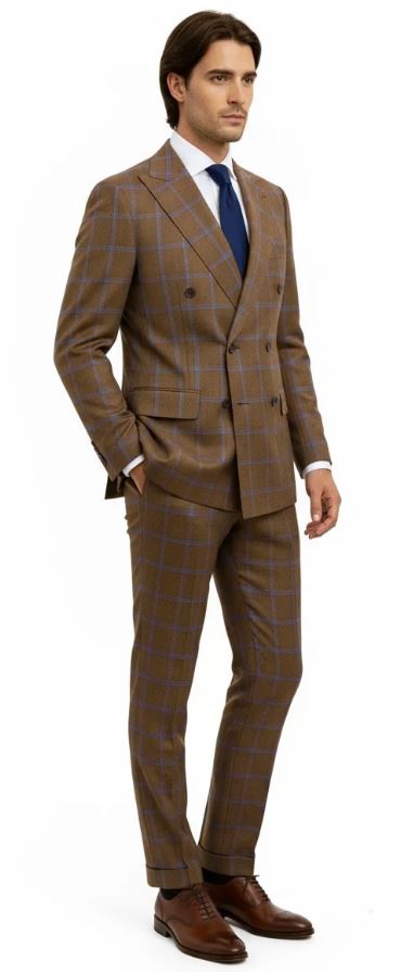 A man is seen wearing the Tiglio Luxe PISTOIA Modern Fit Double Breasted wool suit by Tiglio, featuring a brown checkered pattern, styled with a blue tie and brown dress shoes against a plain white background.