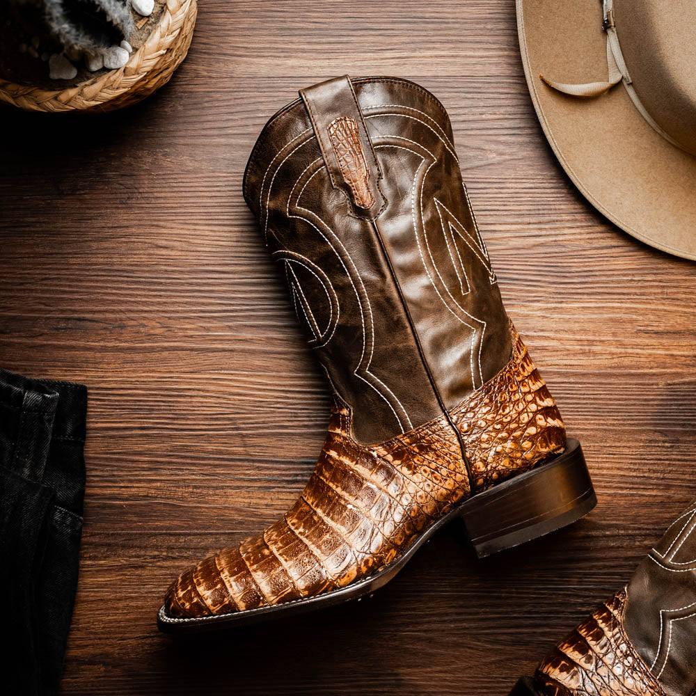 The Marco Di Milano Tucson Stone Orix boots feature genuine caiman belly with brown leather uppers and a crocodile pattern lower, shown from the side and sole.
