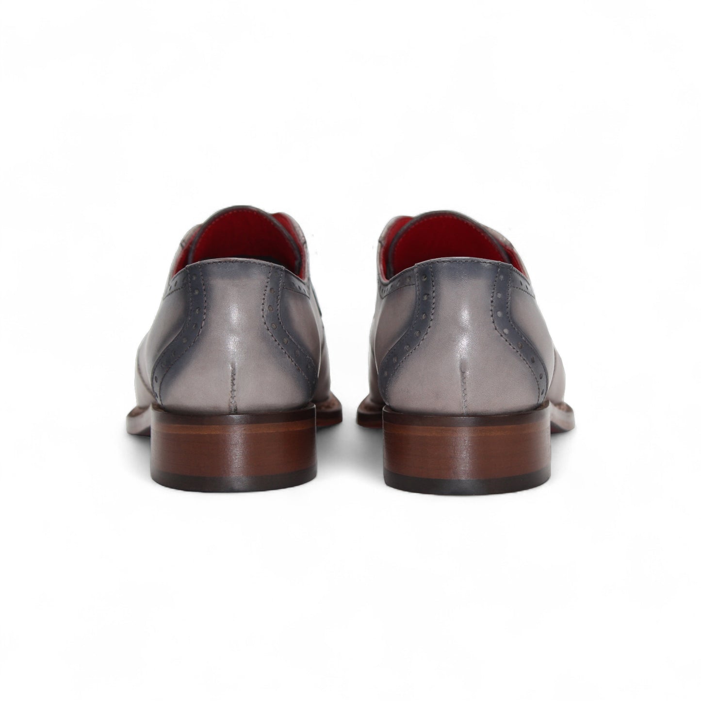 The Fennix Tyler Light Grey by Fennix of Italy is a gray and light gray dress shoe with brogue detailing, red inner lining, and a leather sole, expertly crafted in Italy and displayed in a side profile view.