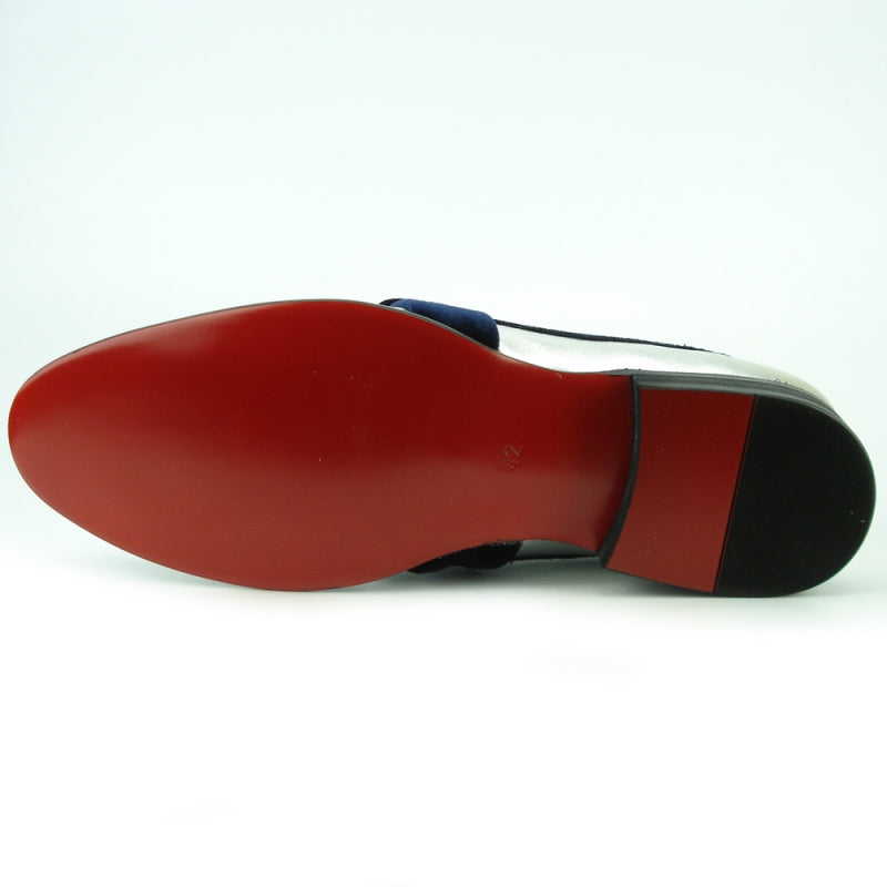 The FI-7356 Silver Fiesso by Aurelio Garcia is a fashion shoe that combines trendiness and elegance, featuring a metallic silver and blue loafer design with a black heel and a wide velvet strap across the top.