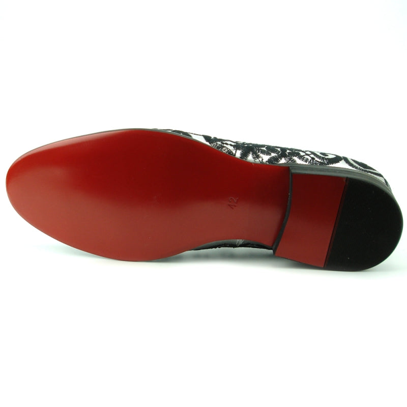 FI-7358 Silver Fiesso by Aurelio Garcia from Fiesso features a silver leather slip-on design with black ornate embroidered lace, making it a true fashion statement.