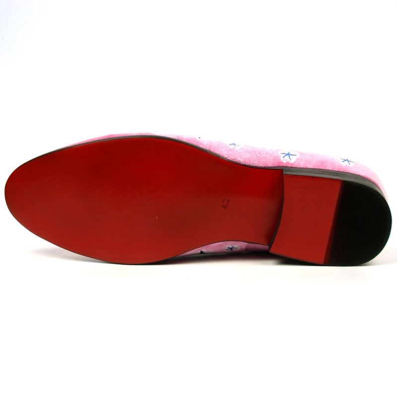 The FI-7413 Pink Flower Slip on Fiesso by Aurelio Garcia from brand Fiesso features a pink velvet upper adorned with vibrant floral embroidery in red, blue, and white patterns, complete with a sleek black heel.