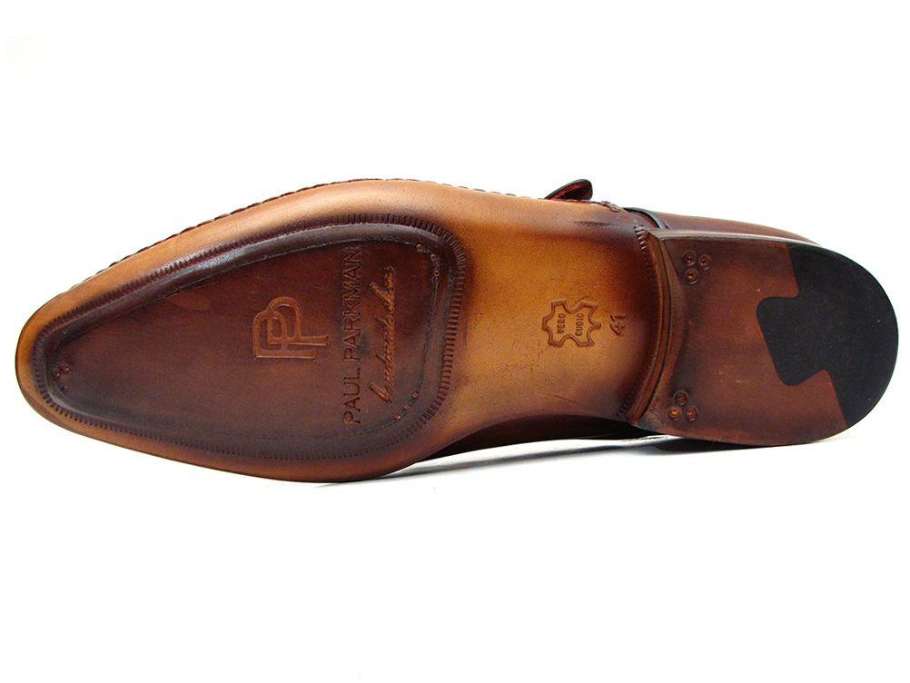 Introducing the Paul Parkman Single Monkstraps Brown Leather - 69V5E: a sophisticated pair of brown leather dress shoes featuring a single monkstrap with buckle detail and visible stitching. The brand label is elegantly placed on the inner sole, highlighting the refined craftsmanship evident in every stitch. These handmade shoes boast a durable leather sole, ensuring they provide lasting wear while showcasing the timeless style of Paul Parkman.