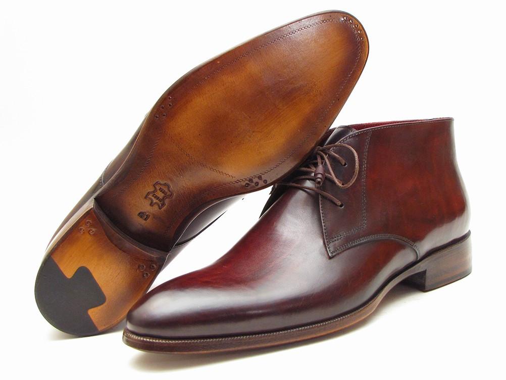 A pair of Paul Parkman Chukka Boots in brown and bordeaux, featuring a polished leather finish with laces, a slight heel, and rounded toes, crafted from hand-painted calfskin for an exquisite touch.