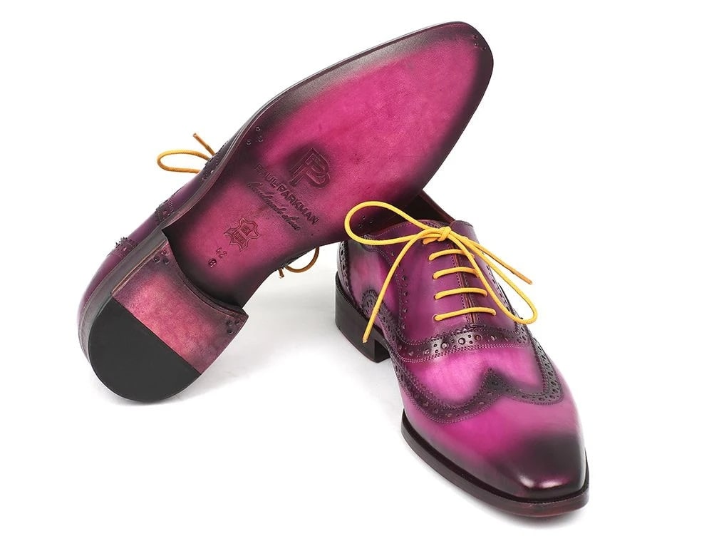 A pair of Paul Parkman Wingtip Oxfords Lilac Handpainted Calfskin - 228-LIL shoes, featuring intricate details and yellow laces, crafted from hand-painted leather with a reflective finish.