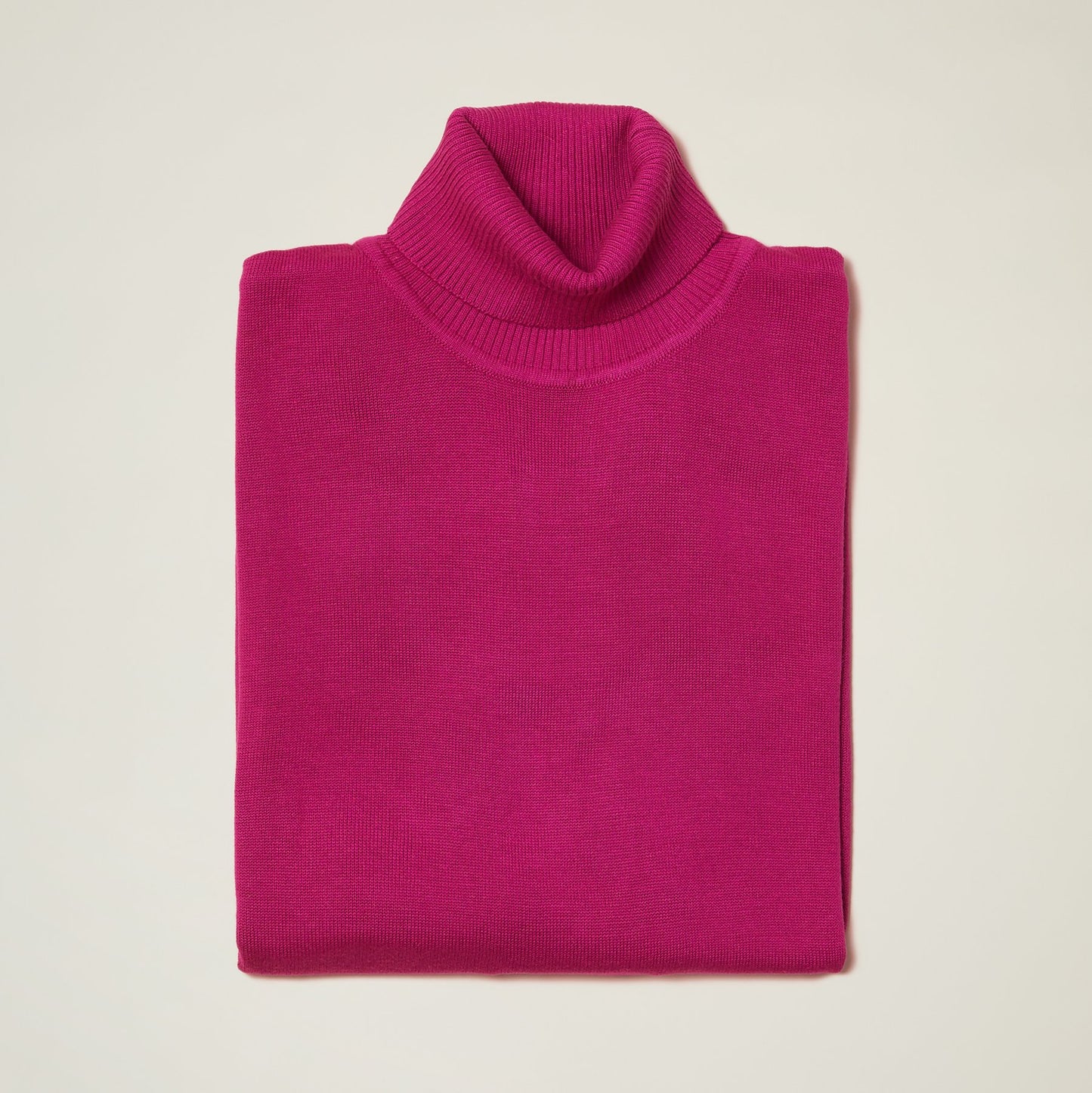 The Inserch Cotton Blend Turtleneck Sweater in Magenta, product number 4708, is beautifully folded on a light background, showcasing its soft cotton blend material.