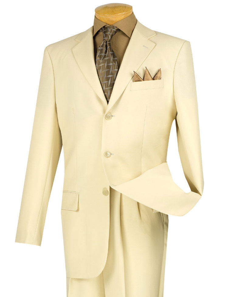 An ivory Vinci Suits Regular Fit 2 Piece 3 Button Suit, featuring a sleek blazer with a brown shirt, patterned tie, and pocket square, is elegantly showcased on a mannequin. The double-pleated pants offer style and easy alteration for any discerning gentleman.