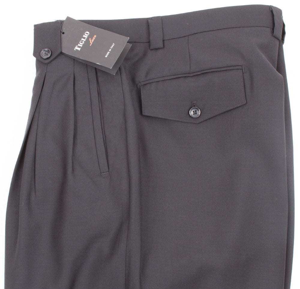 The Tiglio Luxe Black Wide Leg Dress Pants, made from pure wool with excellent craftsmanship, include a buttoned pocket and are displayed on a white background.