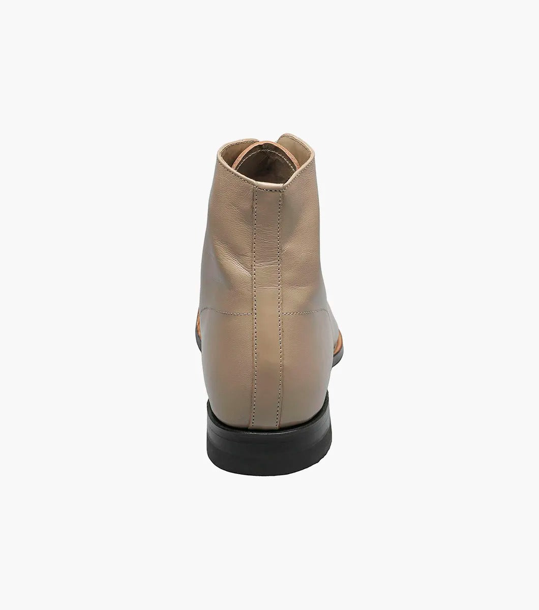 The Stacy Adams Madison Cap Toe Boot in taupe kidskin leather features a low black heel and Goodyear welt, shown as a single boot against a white background.