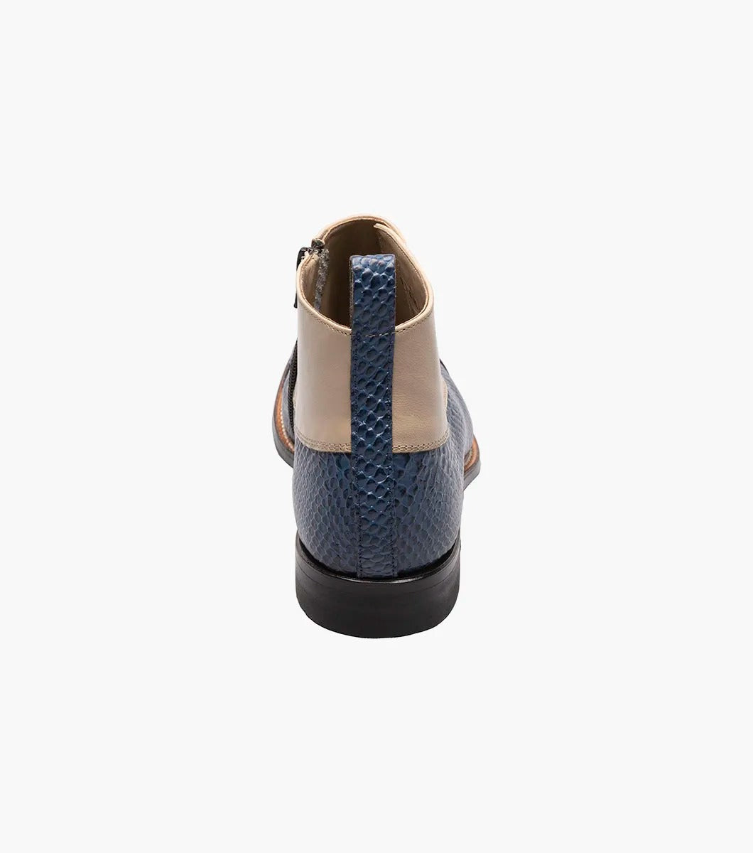 The STACY ADAMS Madison Spectator Spat Cap Toe Demi Boot (Blue Multi) features beige kidskin at the top, blue reptile-patterned leather, black buttons, and a low black heel.