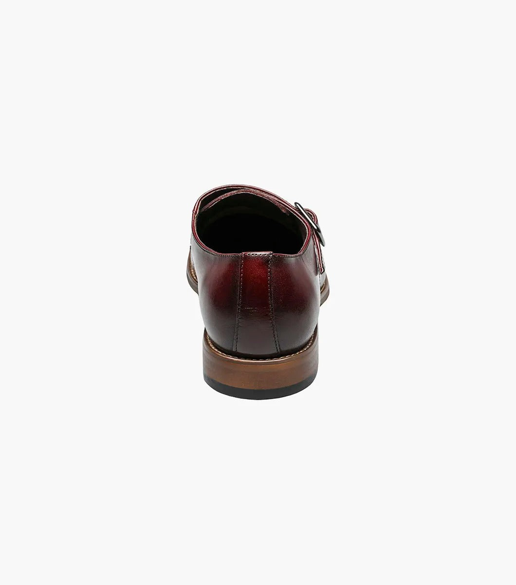 The Stacy Adams Desmond Cap Toe Monk Strap in burgundy features a buckle closure, cap toe, and memory foam insole for comfort. Shown as a single dress shoe on a white background. Brand: STACY ADAMS, Style: 25162-601.