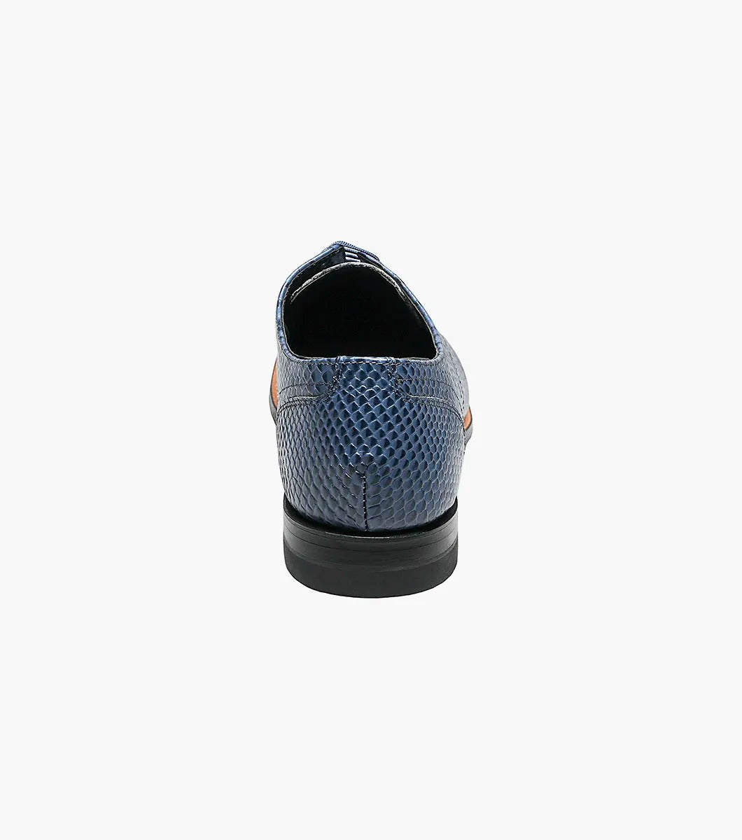 The STACY ADAMS Madison Anaconda Plain Toe Oxford in blue (00055-400) features an anaconda print leather upper, lace-up design, and low black heel, shown as a single dress shoe against a white background.