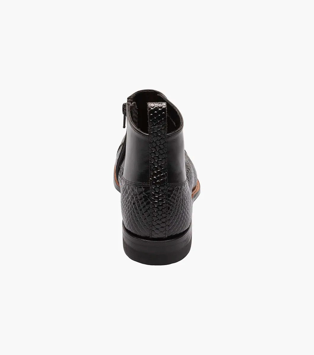 The STACY ADAMS MADISON Spectator Spat Cap Toe Demi Boot in black features a textured pattern, button detailing, Goodyear welt construction, and a convenient pull tab at the back.