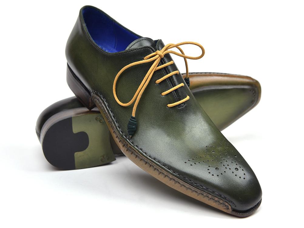 Paul Parkman presents the Opanka Construction Oxfords in green, elegantly crafted from hand-painted leather and boasting a medallion toe design. They feature tan laces and a striking blue lining, making them the perfect statement piece for any wardrobe.