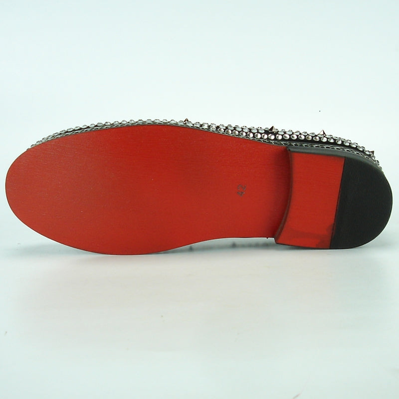 The FI-7119 Black Fiesso by Aurelio Garcia, from the Fiesso brand, is a slip-on fashion shoe featuring a leather upper embellished with silver studs and rhinestones, displayed gracefully against a white backdrop. Its cushioned insole guarantees both comfort and style.