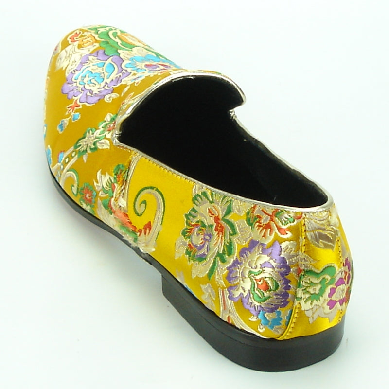 A yellow slip-on Fiesso fashion shoe from the FI-7151 collection by Aurelio Garcia, featuring a vibrant floral and swirl pattern.