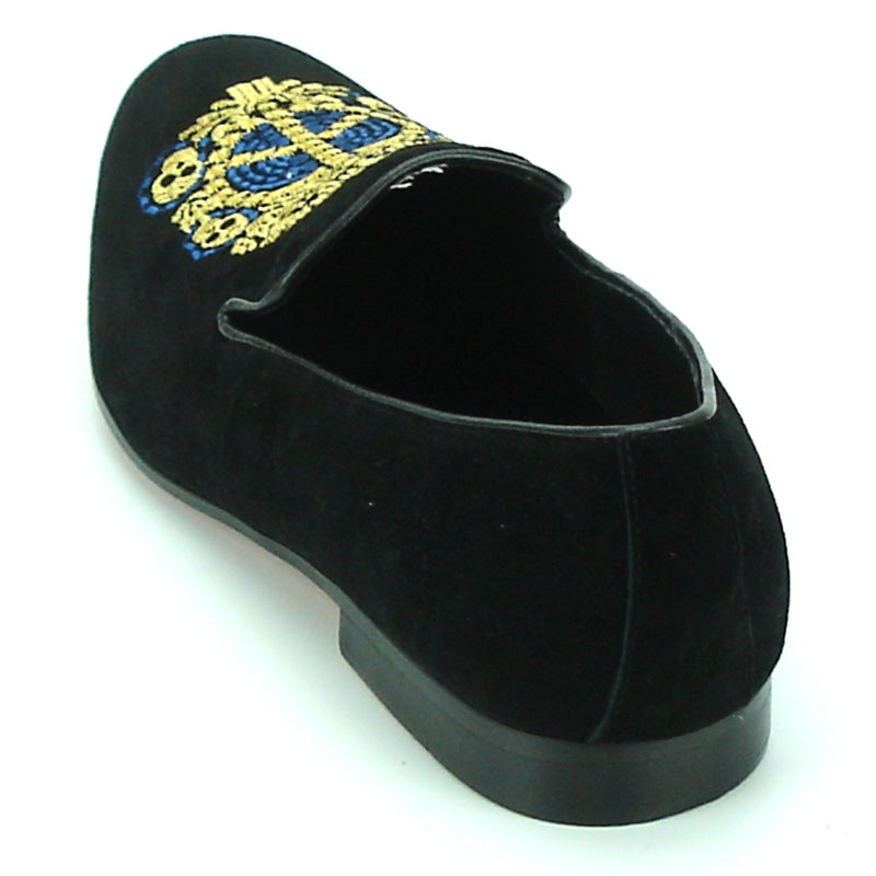 The FI-7181 Black Fiesso by Aurelio Garcia from Fiesso is a slip-on fashion shoe with a decorative gold and blue embroidered emblem on the leather upper, featuring a cushioned insole for added comfort.