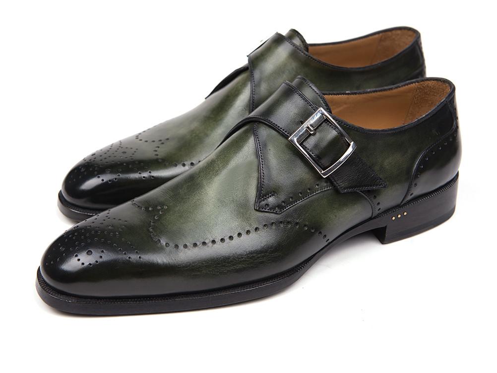 A pair of Paul Parkman Wingtip Single Monkstraps Green - 98F54-GRN shoes, crafted in green leather with polished perforated detailing and a sleek buckle, features one shoe upright while the other lies gracefully on its side.