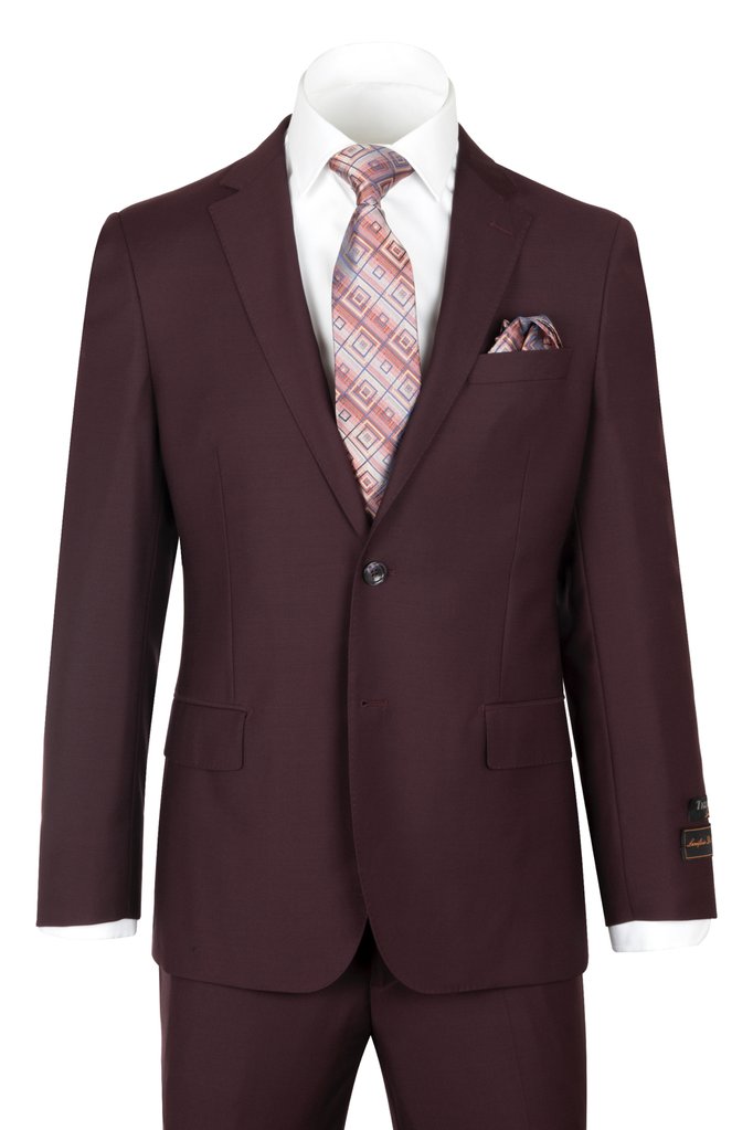 The Tiglio Luxe Novello Burgundy Suit showcases a refined European fit, complete with a geometric patterned tie and matching pocket square on a sleek white shirt, all meticulously crafted from exquisite Italian wool by Tiglio.
