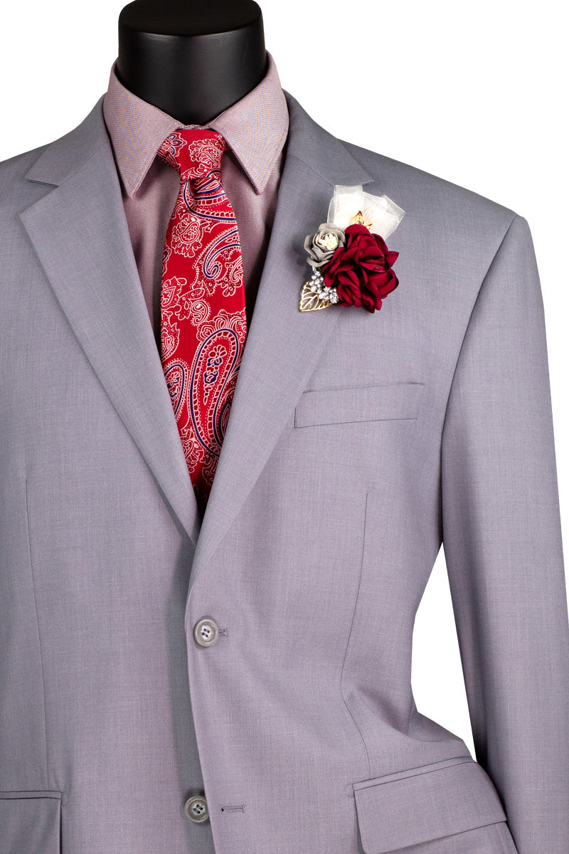 A mannequin displays Vinci Suits' 2 Piece Suit with a 2" Adjustable Waist Band (Light Gray) F-2C900, featuring a notch lapel and paired with a red paisley tie. The ensemble includes a boutonnière of red and white flowers, offering elegance with its luxurious wool feel.