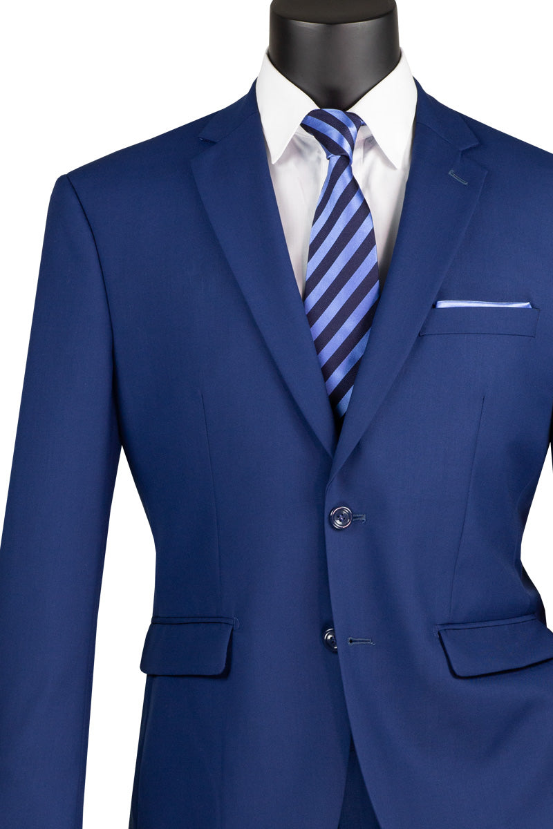A mannequin wears a Vinci Suits 2-piece suit (F-2C900) in twilight blue, with a single-breasted jacket featuring a notch lapel. A white shirt and matching striped tie complete the ensemble, emphasizing the luxurious wool feel.