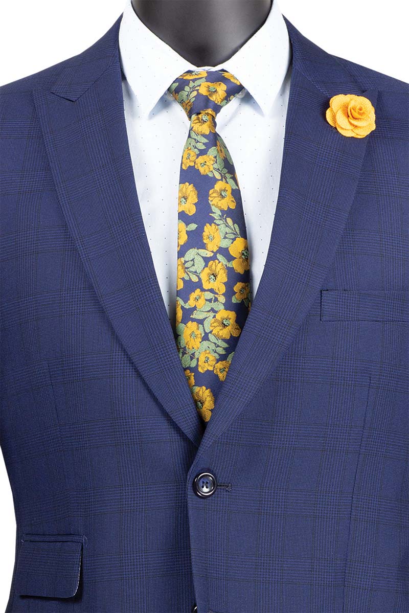 A mannequin displays the Vinci Suits "Modern Fit 2 Piece Windowpane Suit (Blue) MRW-1" with a yellow rose lapel pin and a floral blue and yellow tie, exuding wrinkle-resistant sophistication and timeless style.