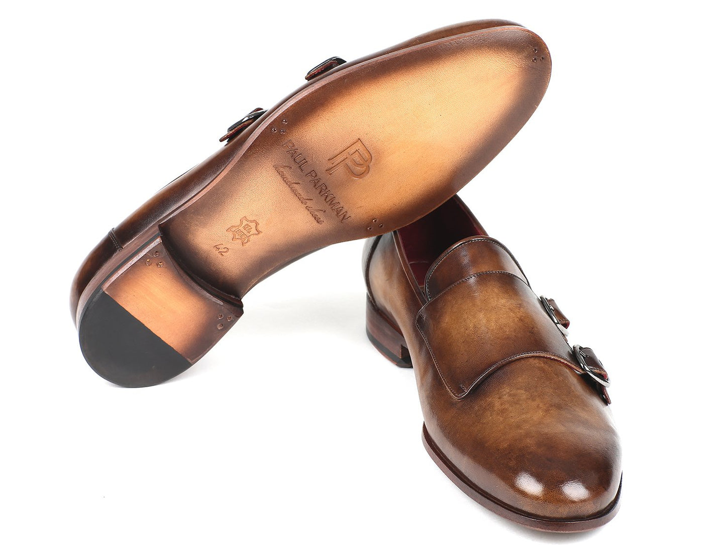 A pair of elegant olive double monkstraps by Paul Parkman, crafted from hand-painted calfskin and featuring a stylish buckle detail, set elegantly against a white backdrop.