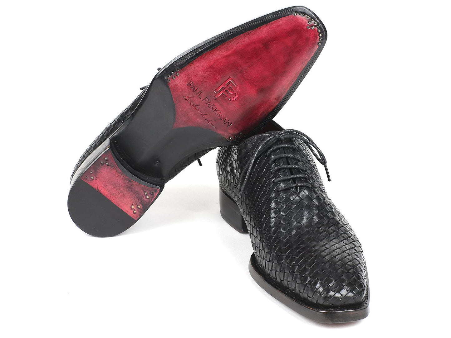 The Paul Parkman Black Woven Leather Oxfords - 044WN86, showcased from a slightly angled front view, highlight their refined craftsmanship with hand-painted double leather soles and laces.