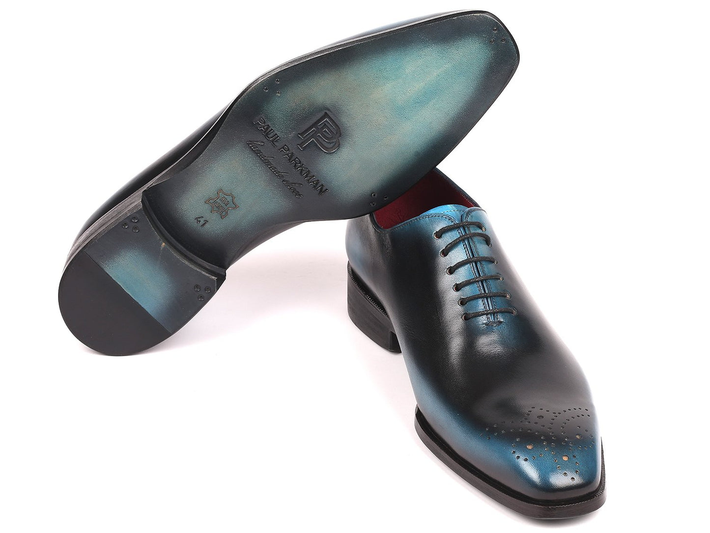 The Paul Parkman Black & Blue Wholecut Oxfords - KR884BLU showcase an exquisite design made from hand-painted calfskin, seamlessly blending style and artistry.