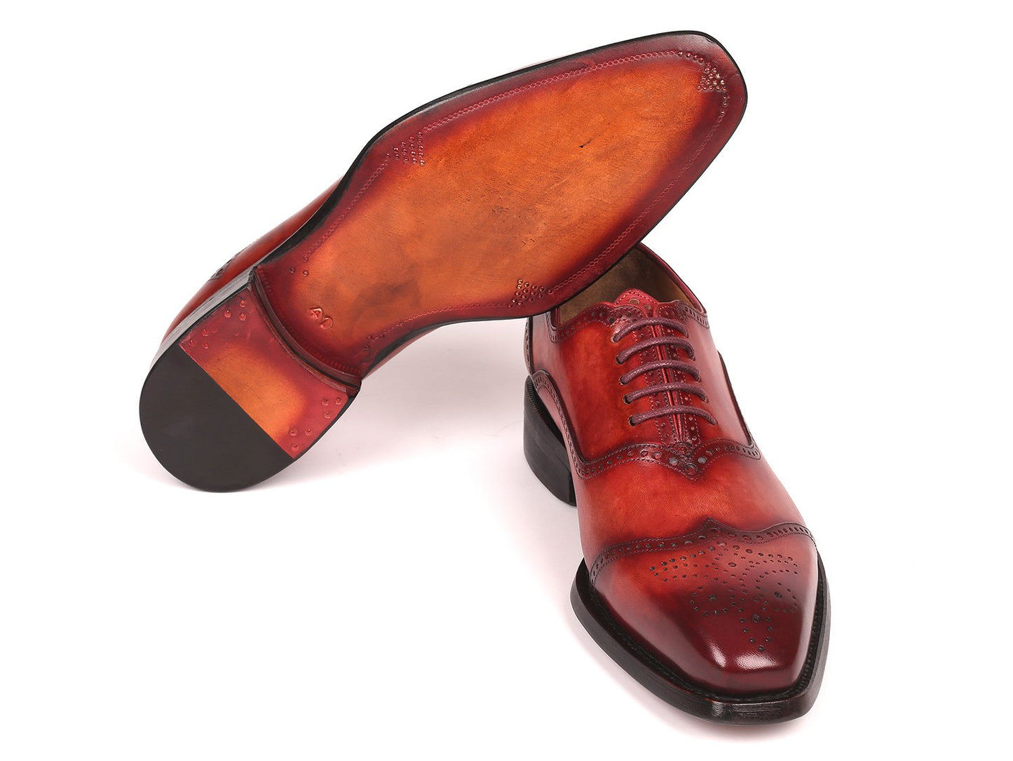 A pair of Paul Parkman Goodyear Welted Oxford Shoes Reddish Brown - 094-RDH, featuring a sleek design with laces and intricate perforations in polished reddish brown leather, expertly crafted for durability.