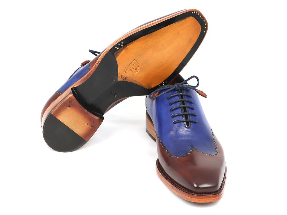 Introducing the Paul Parkman Wingtip Oxford Goodyear Welted Blue & Brown - 81BLU57, a refined creation from Paul Parkman. These shoes feature calfskin uppers in an elegant two-tone design with blue and brown accents, complemented by laces and sturdy wooden soles. Expertly handmade with Goodyear welted construction, they promise unmatched durability and stylish sophistication.