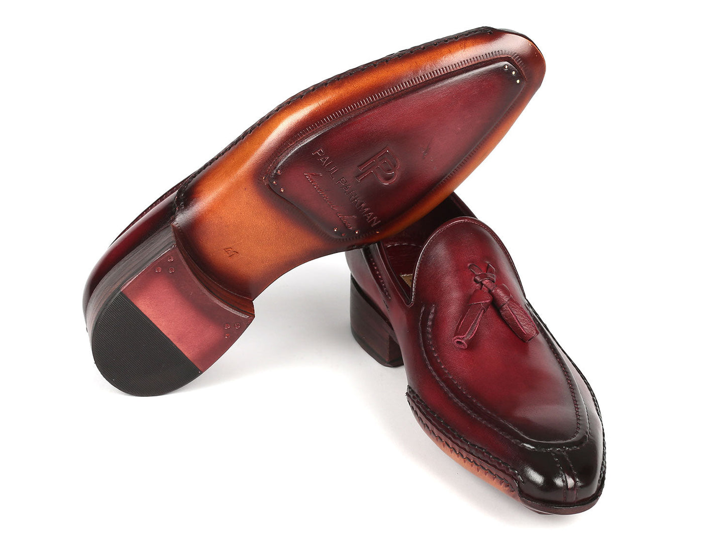 The Paul Parkman Hand-Sewn Tassel Loafers Bordeaux - 082-BRD, crafted by Paul Parkman, are a pair of men's shoes that feature hand-painted burgundy leather with dark soles and boast a polished finish on a white background.