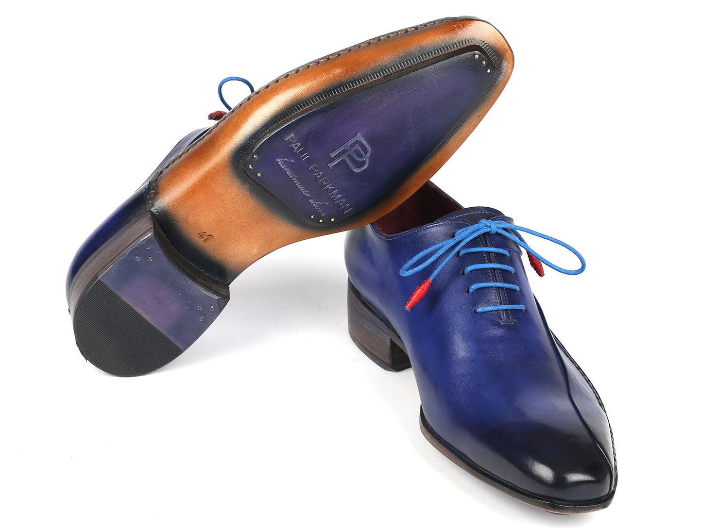 The Paul Parkman Blue Leather Oxford Shoes, featuring a side hand-sewn design with blue laces and red aglets, are stacked stylishly on a white background.