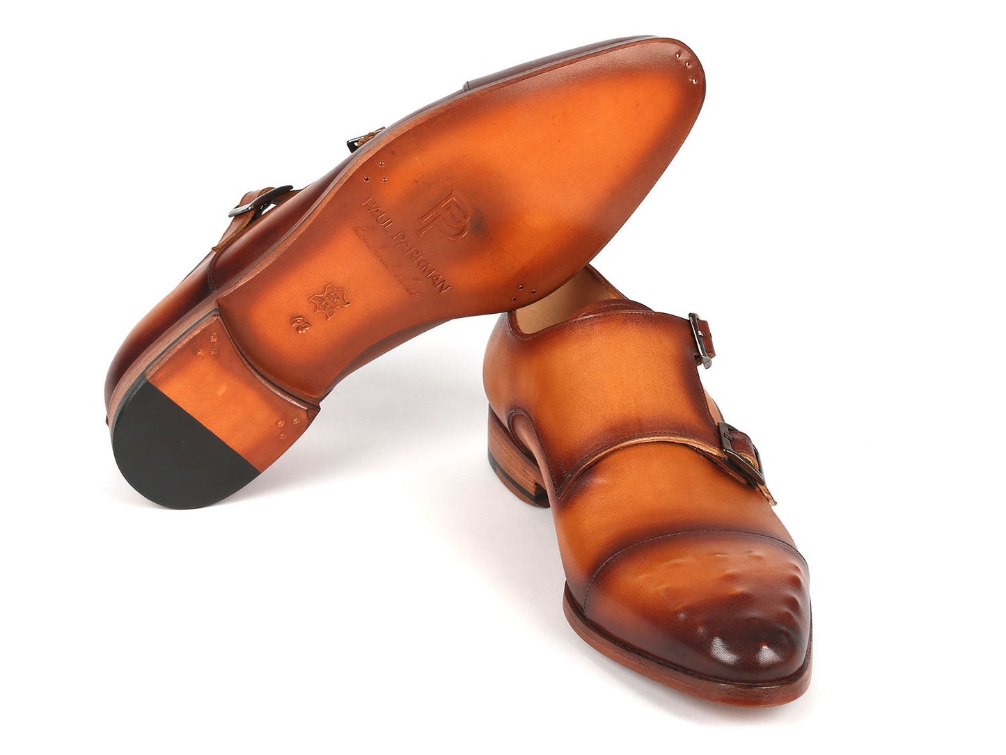 Paul Parkman's light brown studded cap toe monkstraps, style 047-CML, are crafted from hand-painted leather and feature a polished finish with decorative perforations for a bespoke touch.