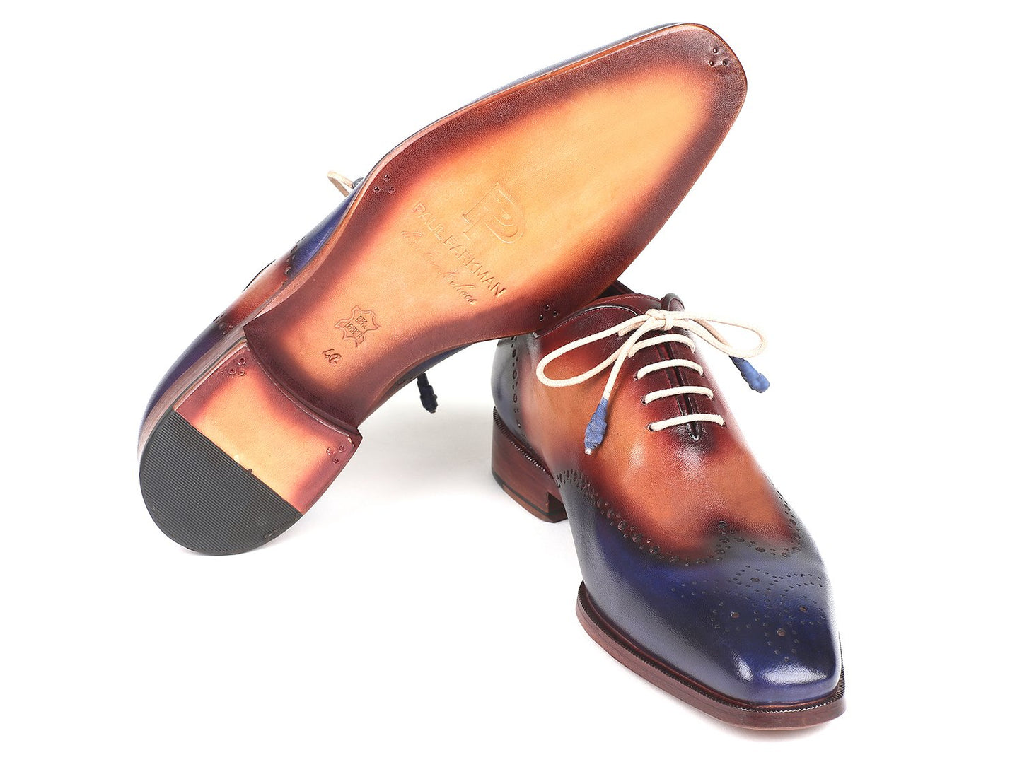 Introducing the Paul Parkman Blue & Camel Wingtip Oxfords - 097BX11: a pair of stylish, handmade shoes crafted from hand-painted leather showcasing a gradient pattern of blue, brown, and burgundy. These made-to-order brogues feature decorative perforations and white laces.