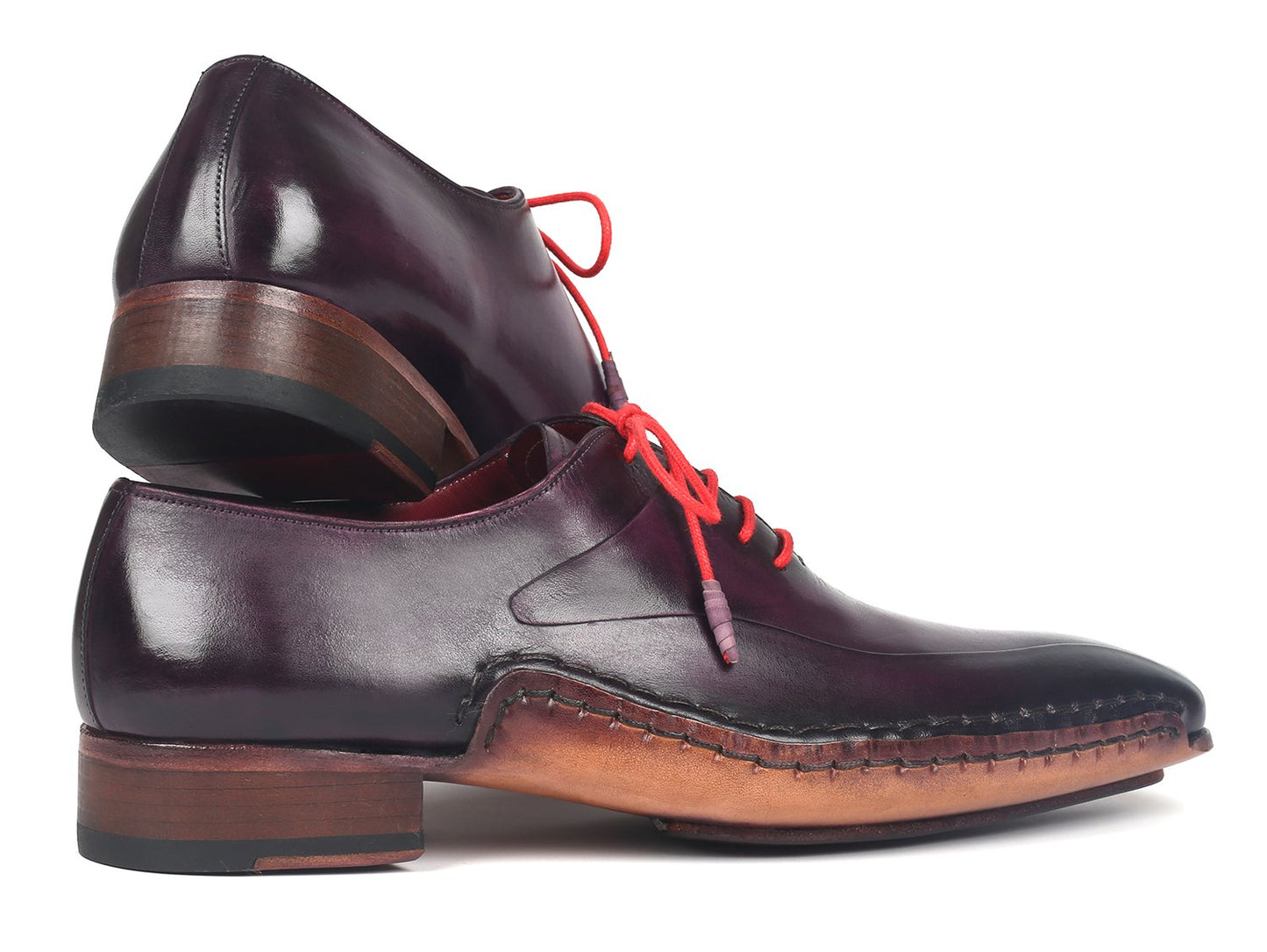 A pair of Paul Parkman Purple Leather Oxfords Side Hand-Sewn - 018-PRP, crafted from premium calfskin in a dark purple shade, featuring distinctive red laces and brown soles with Opanka construction.