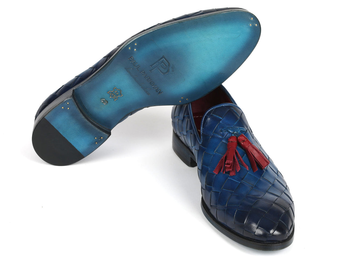 Paul Parkman presents the Big Braided Tassel Loafers in Blue (6623-BLU), featuring intricate hand-painted woven leather and striking red tassels, beautifully displayed against a white background to highlight their bespoke design.