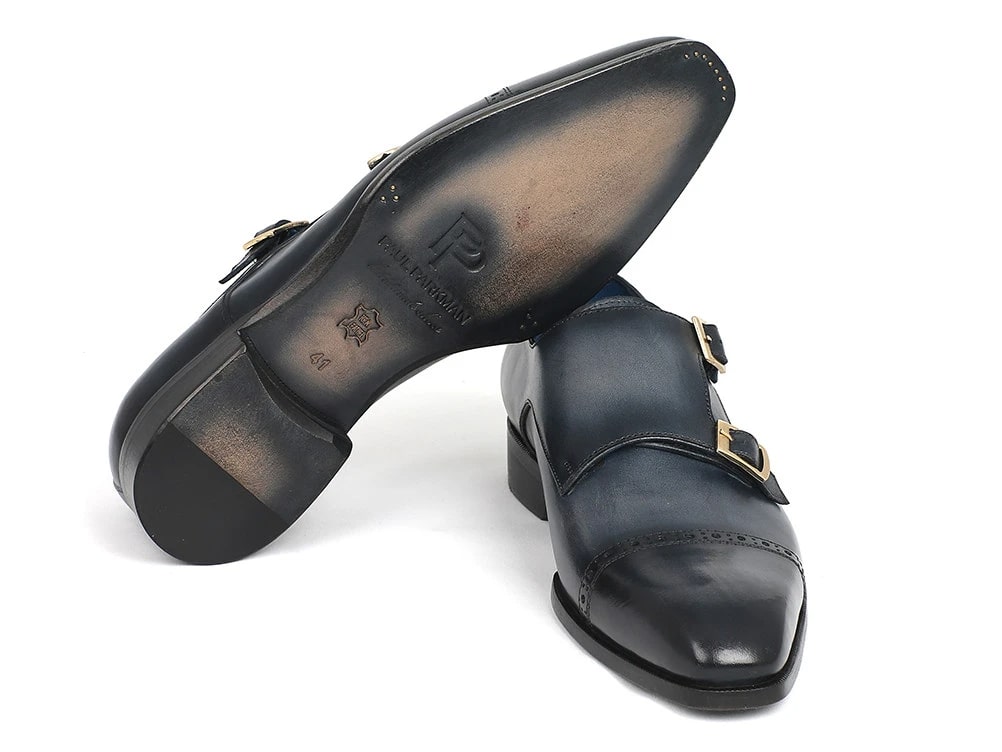 A pair of navy Paul Parkman Captoe Double Monkstraps, expertly crafted with hand-painted leather and featuring a polished finish and decorative stitching, displayed against a white background.
