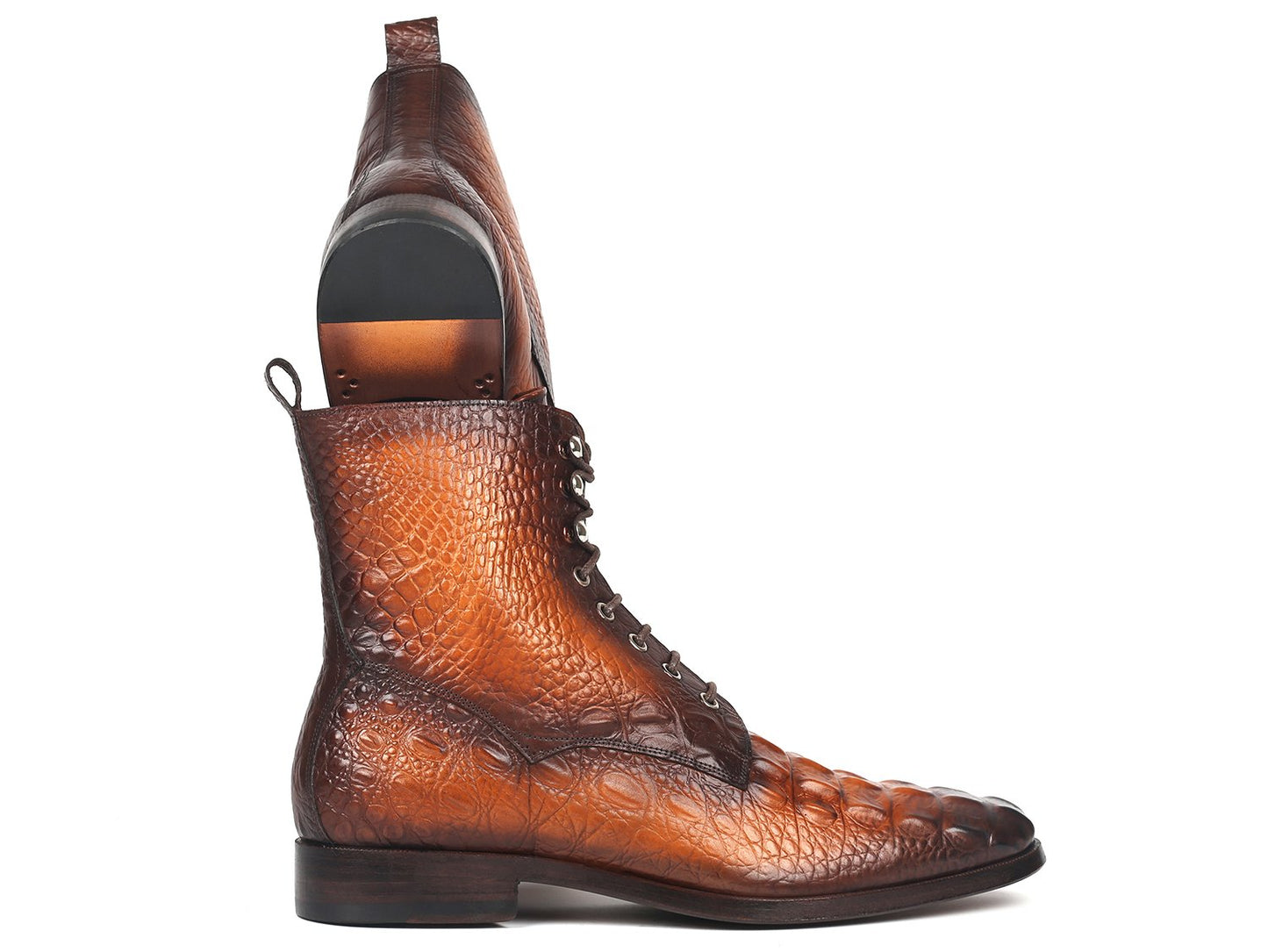 A pair of Paul Parkman brown croco embossed leather lace-up boots (BT744-BRW), elegantly crafted and made-to-order. One boot stands upright, while the other leans against it, highlighting their distinctive charm.