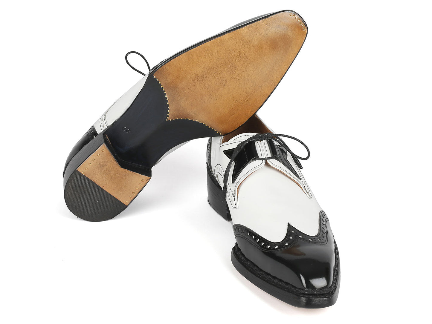 Introducing the Paul Parkman Norwegian Welted Wingtip Dress Shoes in Black & White (Model 8505-BNW), crafted with a sophisticated wingtip derby design. These elegant shoes feature bow laces, intricate decorative perforations, and are completed with a luxurious handcrafted leather sole.