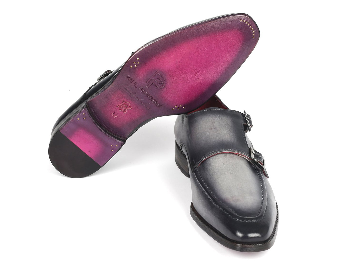 A pair of elegant, polished gray leather double monkstrap shoes by Paul Parkman, featuring silver buckles and a striking red interior lining, meticulously crafted as a made-to-order product.