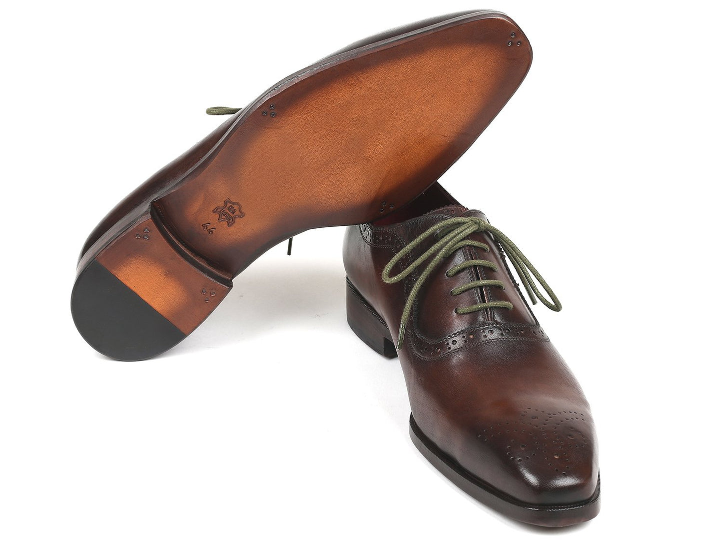 A pair of Paul Parkman Brown Medallion Toe Oxfords - FS78BW, crafted by Paul Parkman, features exquisite hand-painted leather with decorative perforations and green laces.