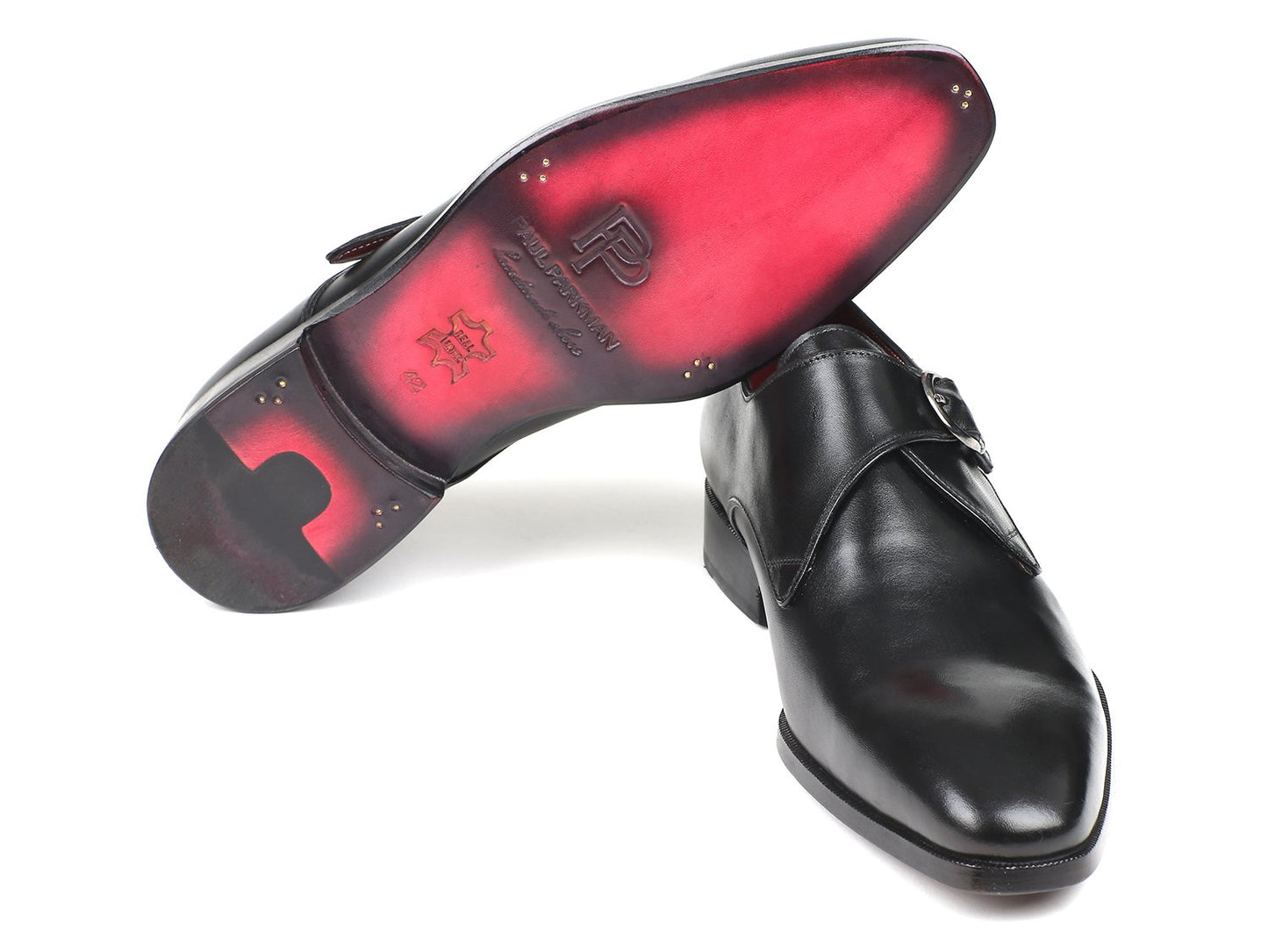 The Paul Parkman Black Leather Single Monkstraps - 011BLK54 showcase a sleek black exterior with a buckle design, artfully arranged to display their striking red interior lining, and meticulously crafted from opulent calfskin leather by Paul Parkman.