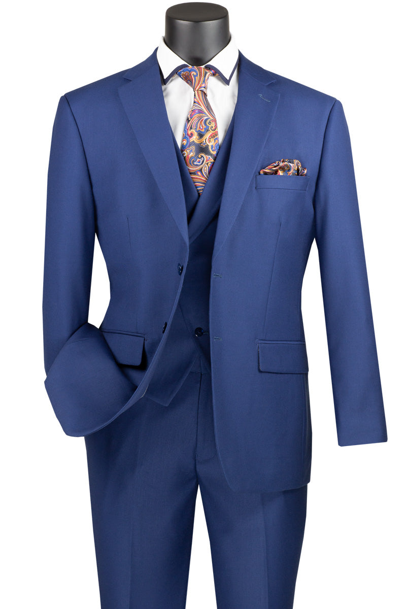 A mannequin highlights a Vinci Suits Modern Fit 3 Piece Single Breasted Suit in blue (MV2TR), complemented by a white shirt, paisley tie, and matching pocket square.